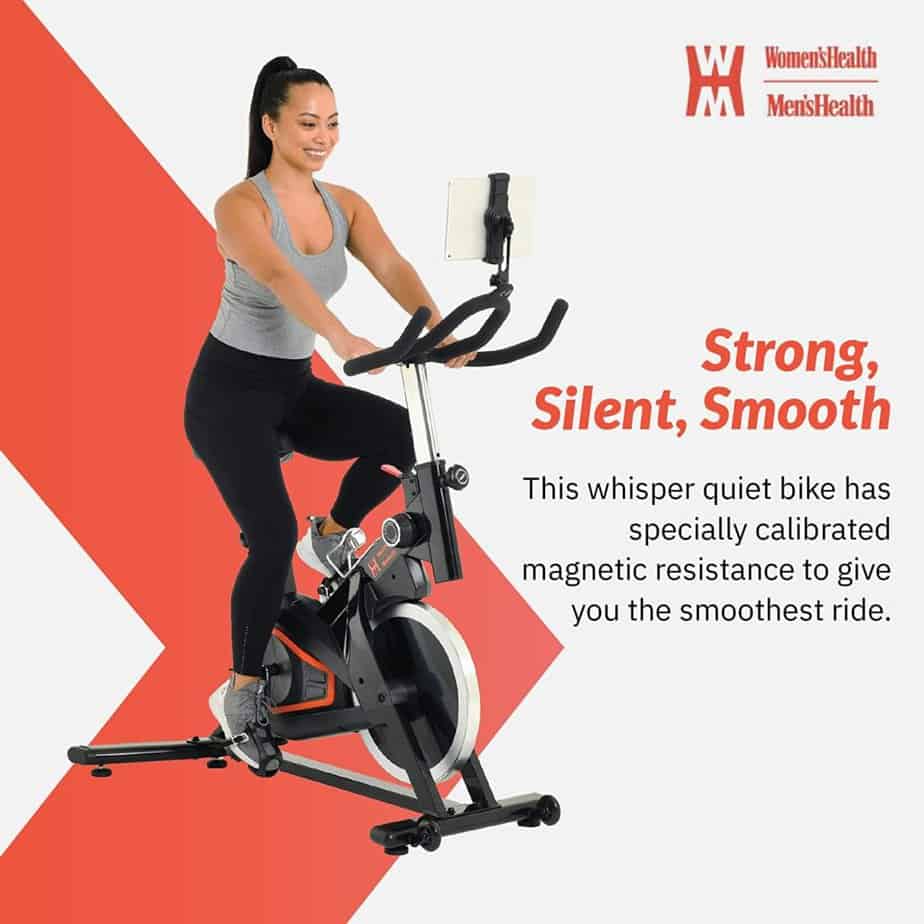 A lady exercises with the Women’s Health Men’s Health Eclipse Indoor Cycling Bike 