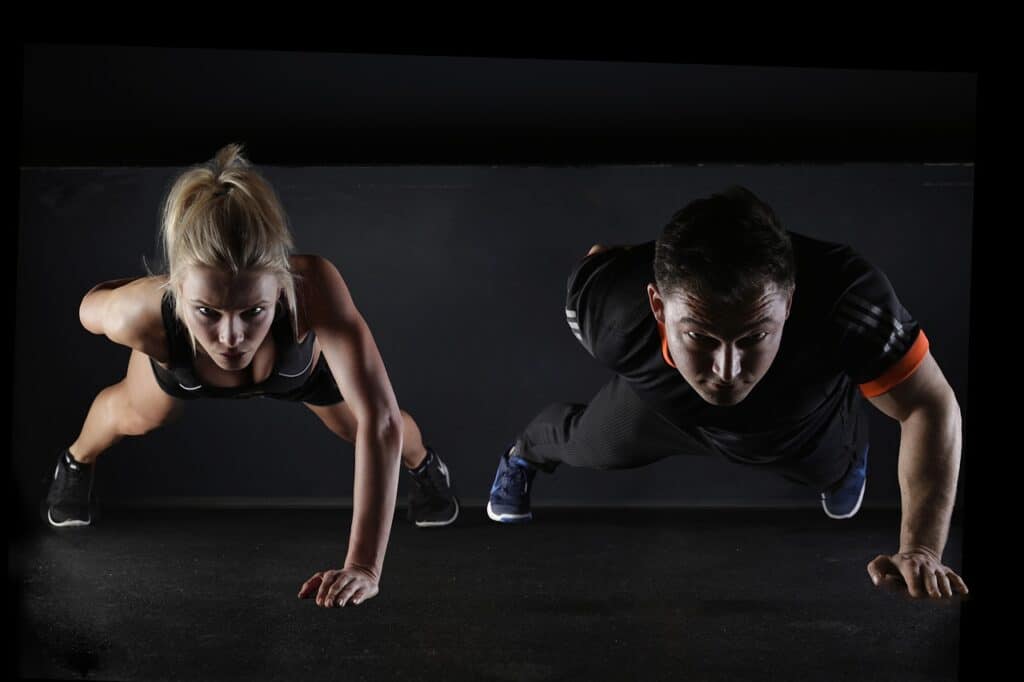 Man and a woman do push-ups