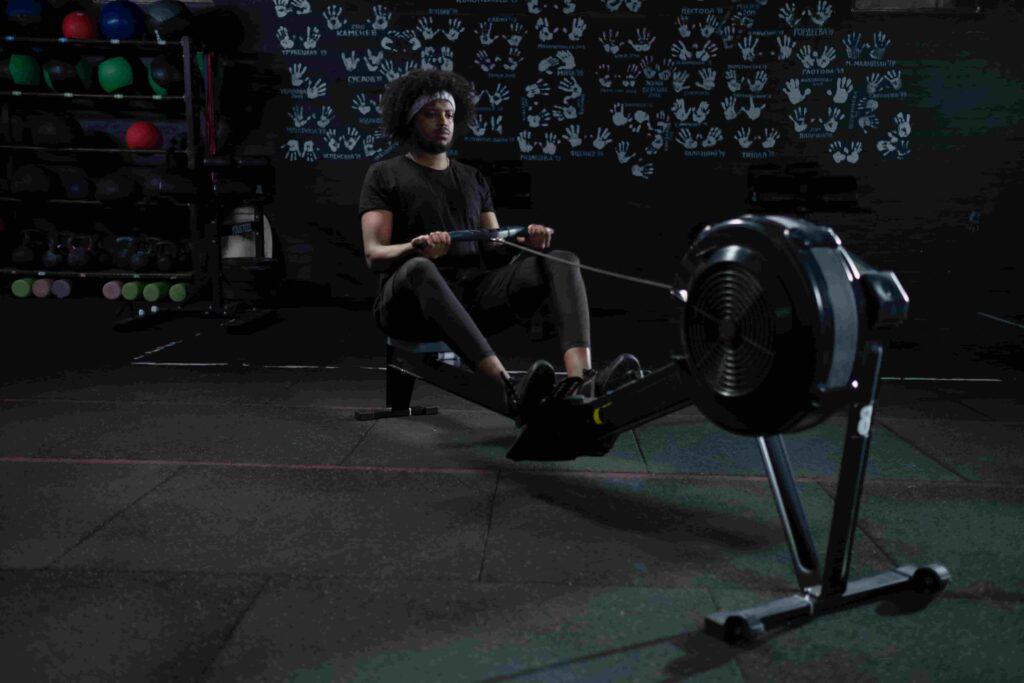 Man exercises on a rowing machine