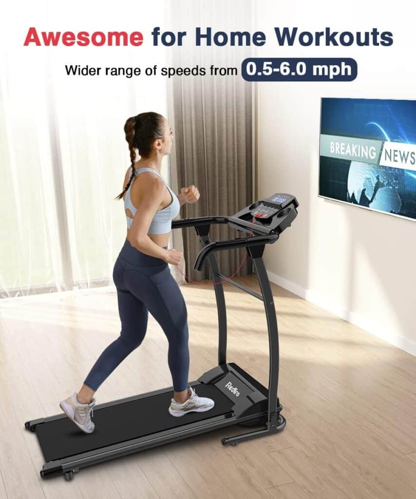 A woman exercises on the Redliro ‎JK105 Folding Treadmill in her living room while watching TV 