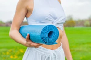Lady carries a yoga mat