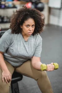 A woman does concentration curls exercise