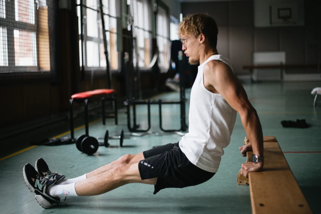 Man performs tricep dips exercise