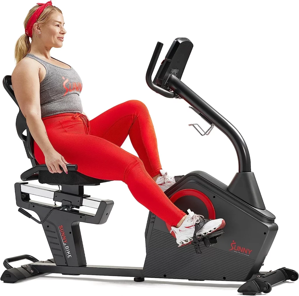 A lady is exercising on the Sunny Health & Fitness SF-4850SMART Recumbent Bike