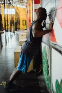 A man does the wall push exercise