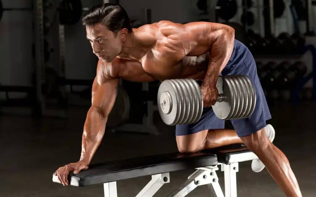 A man does the one-arm row dumbell exercise