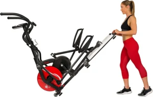 a woman in sports top and red leggings pushing the Sunny Health & Fitness Elliptical Trainer SF-E3865 to storage area